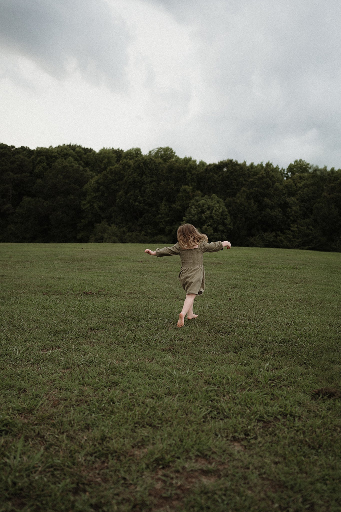 little girl running around a field raleigh preschools