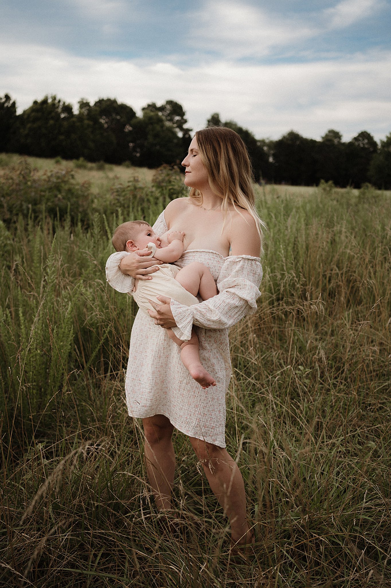 mom breastfeeding her child in a field raleigh baby stores